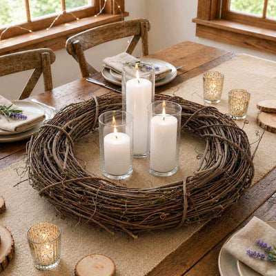 Natural grapevine wreath with pillar candles in glass cylinders on a wooden dining table - thumbnail number 8