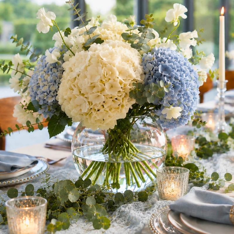 A 5.5" Bubble vase filled with white and blue hydrangeas on a decorated dining table - thumbnail number 7