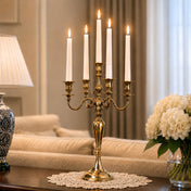 Lit 25-inch gold candelabra with five white taper candles on a wooden console table - thumbnail number 8