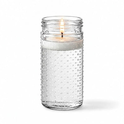 A lit floating white candle in the Hobnail Mason Jar Vase isolated on a solid white background - thumbnail number 3