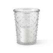 An unlit white pillar candle inside a clear glass Hobnail Candle Holder on a white studio backdrop - thumbnail number 2