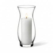 Lit white pillar candle inside a clear 6.5" hana vase on a white background - thumbnail number 3