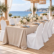 White banquet chair covers at a seaside outdoor dining setup - thumbnail number 5