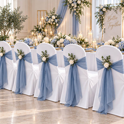 White banquet chair covers with blue sashes and floral decor at a wedding - thumbnail number 2