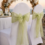White chairs decorated with sage organza sashes tied in bows - thumbnail number 7