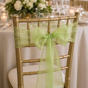 Gold chiavari chair decorated with a sage organza sash tied in a bow - thumbnail number 3