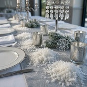 Wedding table runner with white confetti, candles, pine branches, and dinnerware settings - thumbnail number 4