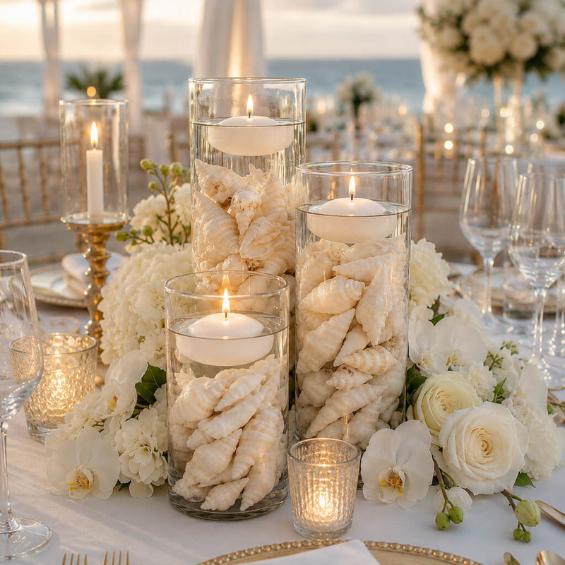 Cylinder vases with floating candles and Conch Shell Vase Filler as a beach wedding centerpiece - thumbnail number 5