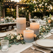 Outdoor dinner table with glowing marble pillar candles and floral greenery decor - thumbnail number 7