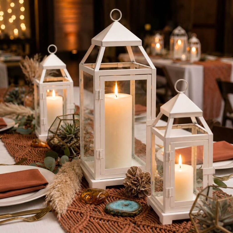 White contemporary metal lanterns with lit candles as centerpieces on a formal event table - thumbnail number 4