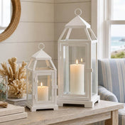 White contemporary metal lanterns with pillar candles on a table with coastal decor - thumbnail number 5