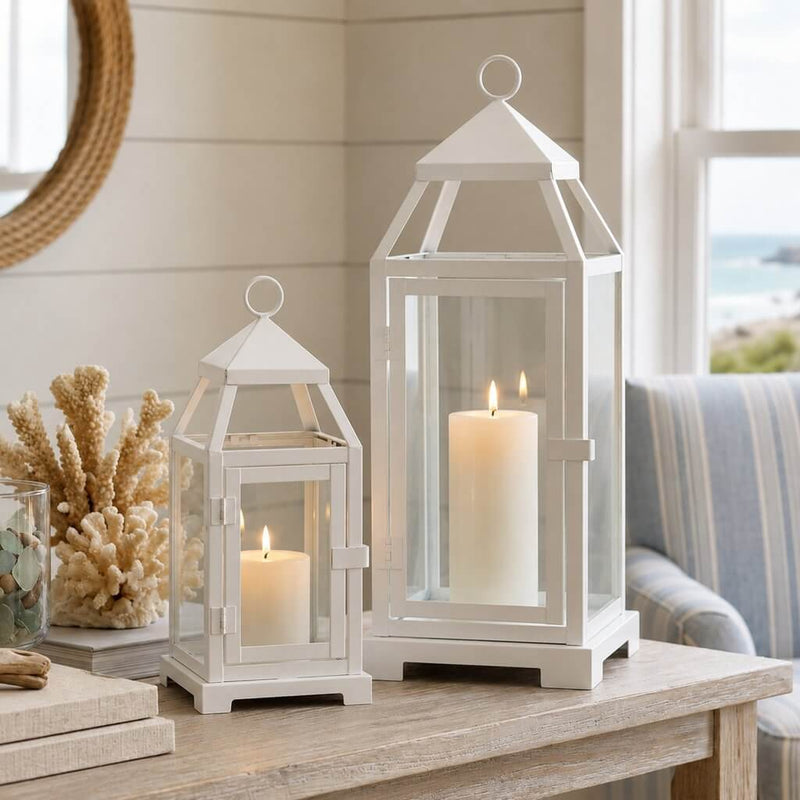 White contemporary metal lanterns with pillar candles on a table with coastal decor - thumbnail number 5