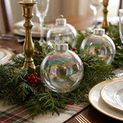 Iridescent glass ornaments styled in holiday greenery table runner with red berries - thumbnail number 9