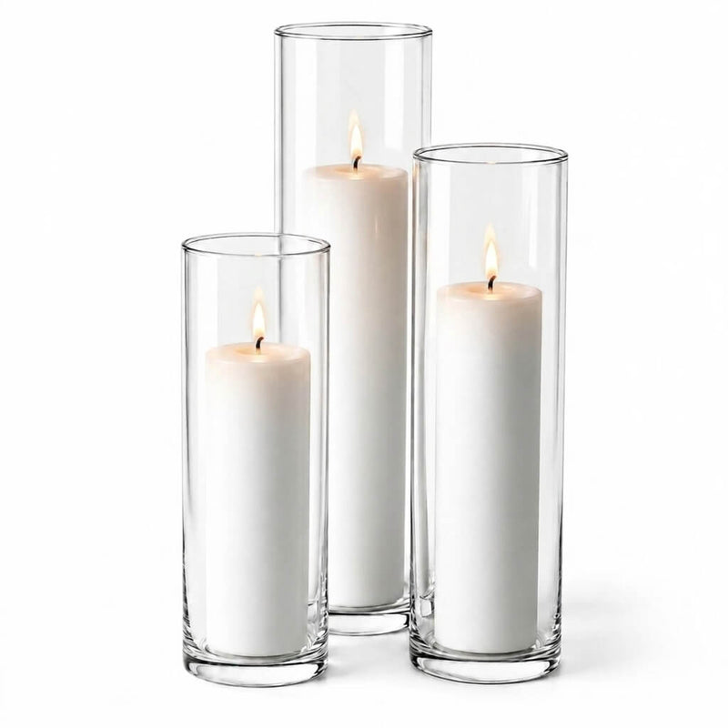Three lit white pillar candles in staggered clear glass cylinder vases - thumbnail number 3
