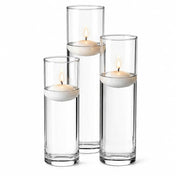 Three tall glass cylinder vases with water and lit floating white candles - thumbnail number 5