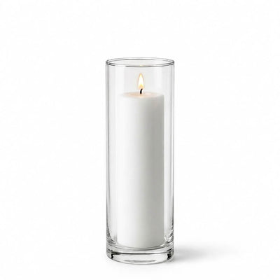 Lit white pillar candle inside a tall clear glass cylinder vase - thumbnail number 3