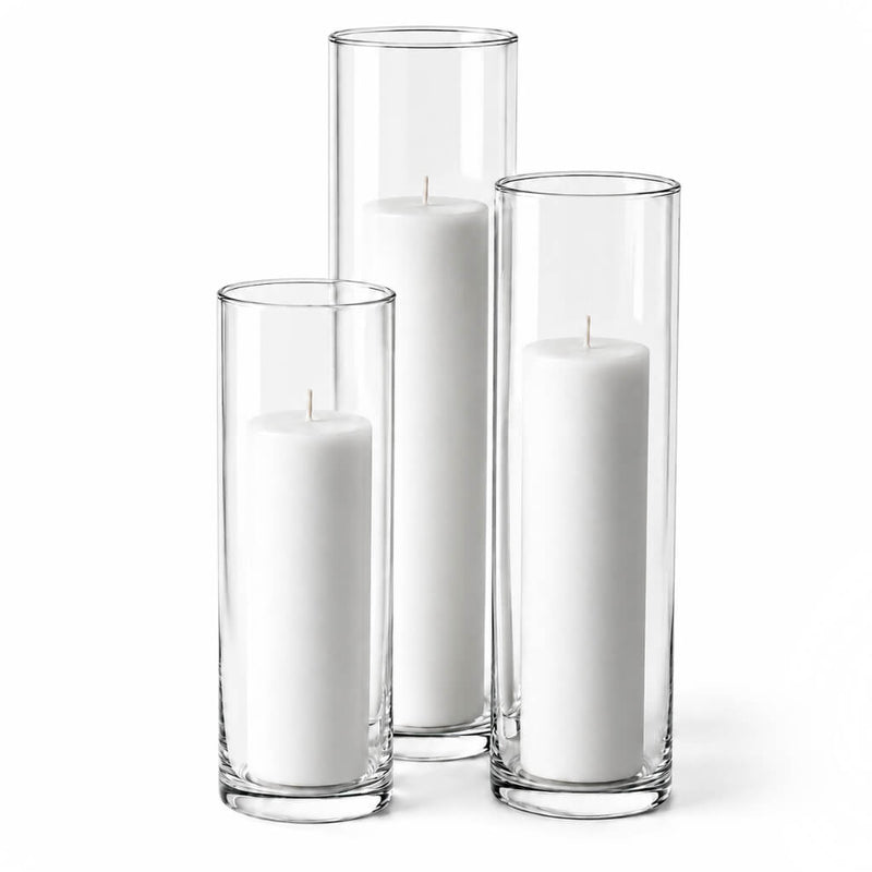 Three white pillar candles in staggered clear glass cylinder vases - thumbnail number 2