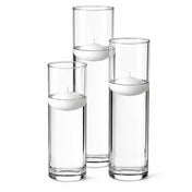 Three tall glass cylinder vases of varying heights filled with water and floating white candles - thumbnail number 4