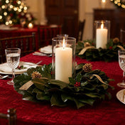 Magnolia wreath with candle and pinecones on table - thumbnail number 4