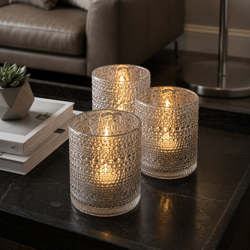 Set of glowing pearly silver candle holders on a modern black coffee table - thumbnail number 6