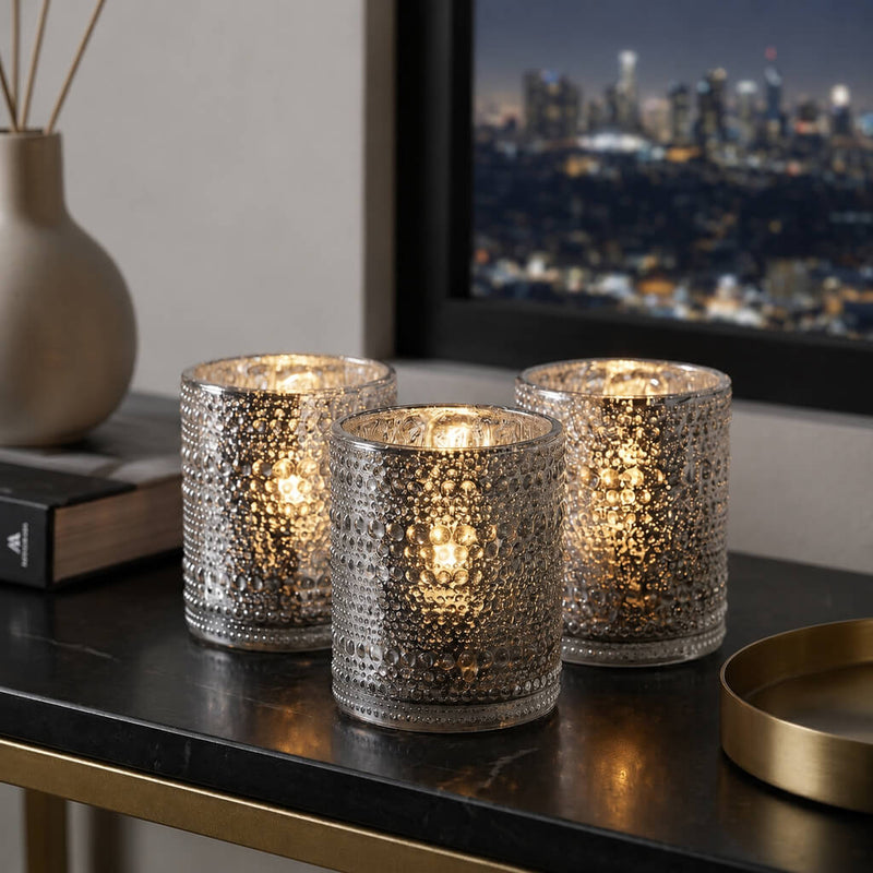 Set of glowing pearly silver candle holders on a modern table with city view - thumbnail number 7
