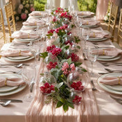 Clear glass ornaments filled with red flowers styled along a wedding table runner - thumbnail number 3