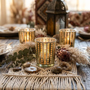 Decorative candles on a table with a textured tablecloth and lantern in the background - thumbnail number 6