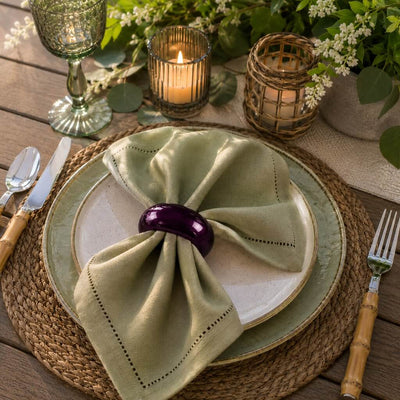 A 2.3-inch eggplant napkin ring holding a folded green napkin on a plate setting - thumbnail number 7