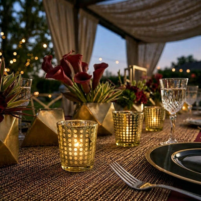 Glowing gold dotted glass holders and red calla lilies on a luxury gala table setting - thumbnail number 4