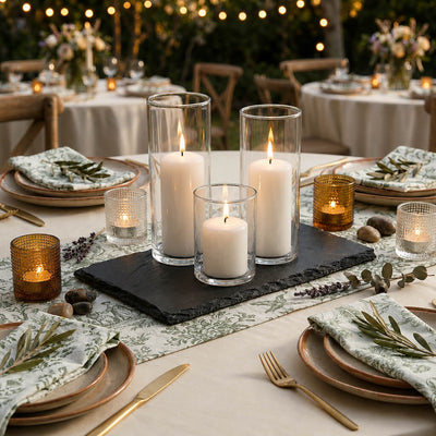 Three white pillar candles in glass cylinders on a black slate coaster centerpiece - thumbnail number 8