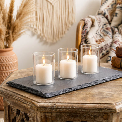 Three white pillar candles in glass on a rectangular black slate coaster - thumbnail number 9