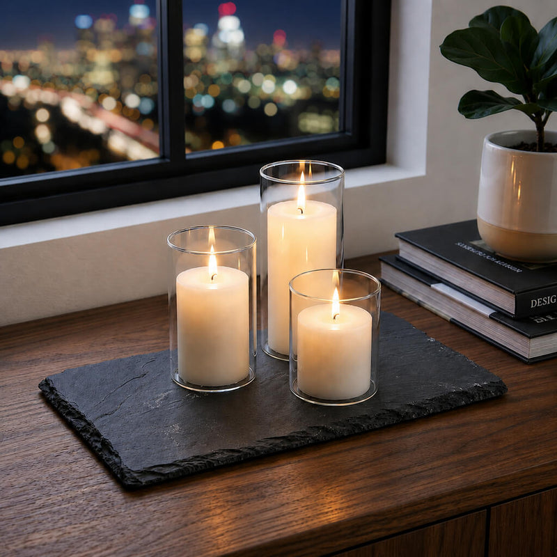 Three glowing candles in glass on a Rectangle Natural Slate Coaster by a window with city views - thumbnail number 10