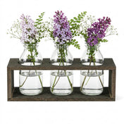 Vintage milk bottle vases with flowers in a wooden stand - thumbnail number 3