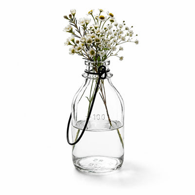 Vintage Bottle Hanging Glass Vase filled with small white flowers - thumbnail number 2
