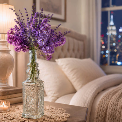 Decorative glass bottle vase with purple flowers in a bedroom - thumbnail number 6