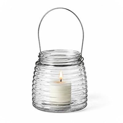 Lit white votive candle in a 4.6" Hanging Horizontal Ribbed Glass Jar with Handle - thumbnail number 3