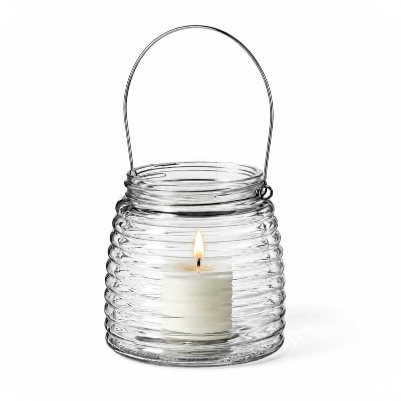Lit white votive candle in a 4.6" Hanging Horizontal Ribbed Glass Jar with Handle - thumbnail number 3