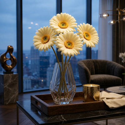 Five pale yellow 24" gerbera daisies in a geometric vase on a wooden tray in a high-rise apartment - thumbnail number 8