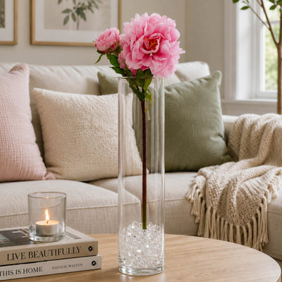 A 22-inch pink peony spray in a tall glass vase filled with clear beads on a coffee table - thumbnail number 7