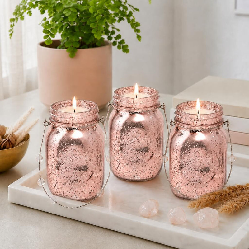 Three rose gold mercury glass mason jars with lit candles on a marble tray - thumbnail number 7