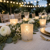 White lace votive candle holders glowing on elegant outdoor dinner table decor - thumbnail number 5