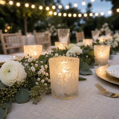 White lace votive candle holders glowing on elegant outdoor dinner table decor - thumbnail number 5