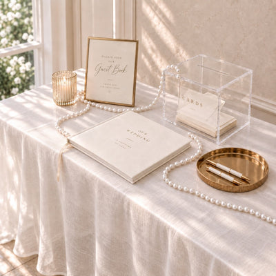 Wedding guest book table adorned with glossy white faux pearl beads and pens - thumbnail number 3