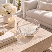 Glass bowl filled with glossy white faux pearl beads resting on a coffee table - thumbnail number 10