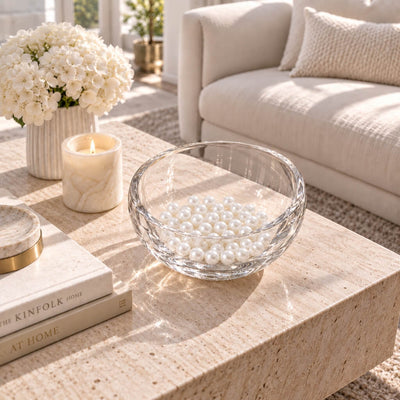 Glass bowl filled with glossy white faux pearl beads resting on a coffee table - thumbnail number 10