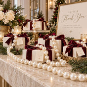 Gift boxes wrapped with velvet bows and draped with strands of white faux pearls for a holiday display - thumbnail number 4