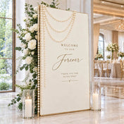 Wedding welcome sign decorated with ivory faux pearl bead strands, flowers, and candles - thumbnail number 7