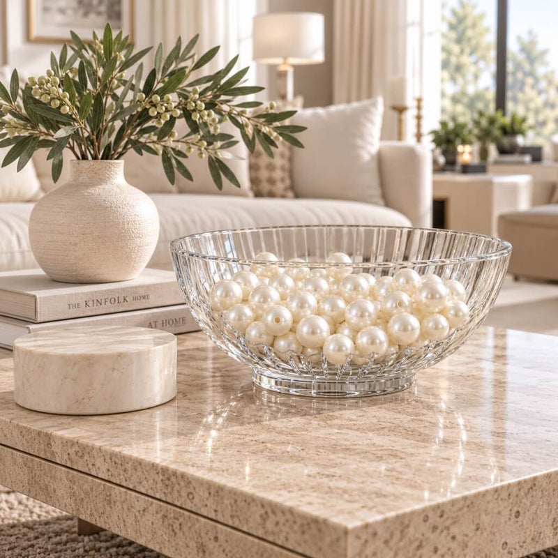 Glass bowl filled with ivory faux pearl beads displayed on a coffee table in a living room - thumbnail number 8