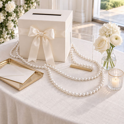 Wedding card box decorated with a bow and white faux pearl bead strands on a table - thumbnail number 4