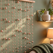 Hanging rose gold faux pearl string beads used as a decorative wall backdrop - thumbnail number 7